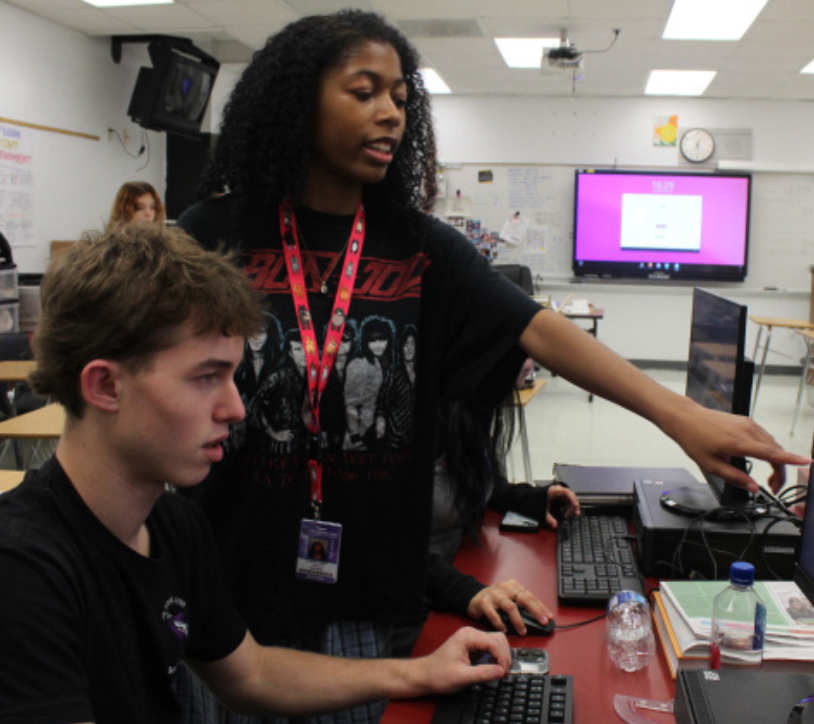 WORKING HARD: Senior Alexis Chery helping newspaper students with ques-
tions and concerns during layout after school